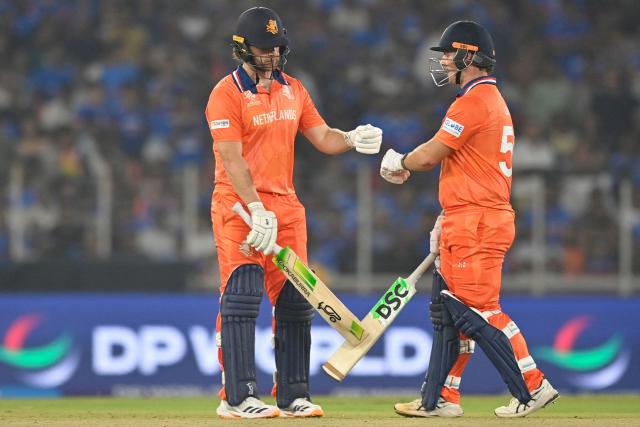 Netherlands' Michael Levitt and Max O'Dowd bump fists during the 2026 ICC Men's T20 Cricket World Cup group stage match between India and Netherlands at the Narendra Modi Stadium in Ahmedabad on February 18, 2026. (Photo by Shammi MEHRA / AFP)