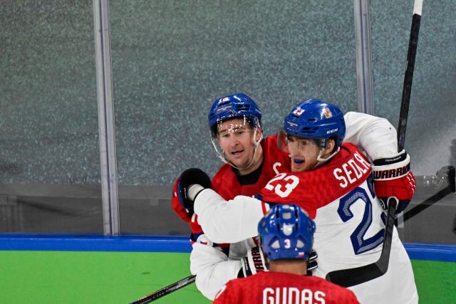 Czech Republic's #23 Lukas Sedlak (R) celebrates with teammates after scoring his team's first goal during the men's play-off quarter-final ice hockey match between Canada and Czech Republic at the Milano Santagiulia Ice Hockey Arena during the Milano Cortina 2026 Winter Olympic Games in Milan, on February 18, 2026. (Photo by Alexander NEMENOV / AFP)