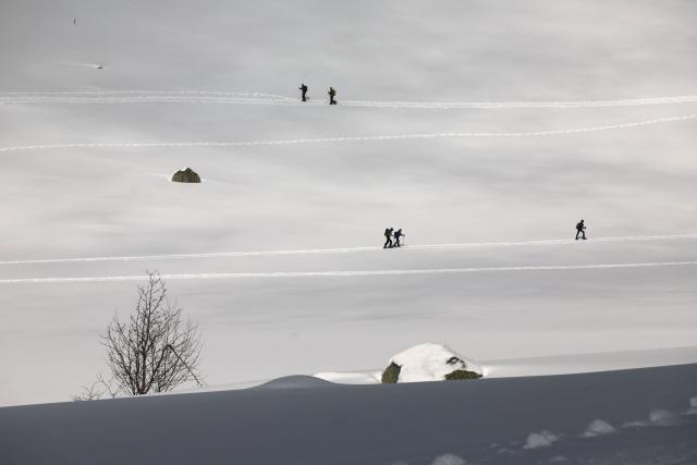 People snowshoe at the Val d'Ese ski resort in Bastelica 50 km from Ajaccio on the French Mediterranean island of Corsica.on February 15, 2026. The Val d’Ese ski resort, standing 1,620 meters high, is one of the few ski resorts in France where people can ski with a view of the sea. (Photo by Pascal POCHARD-CASABIANCA / AFP)