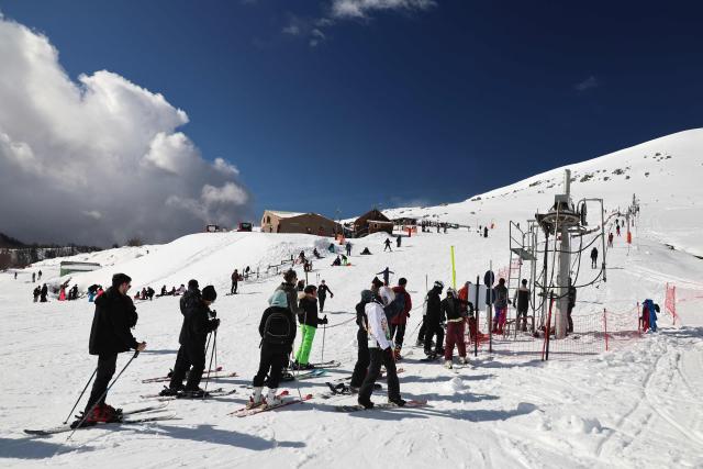 People ski at the Val d'Ese ski resort in Bastelica 50 km from Ajaccio on the French Mediterranean island of Corsica.on February 15, 2026. The Val d’Ese ski resort, standing 1,620 meters high, is one of the few ski resorts in France where people can ski with a view of the sea. (Photo by Pascal POCHARD-CASABIANCA / AFP)