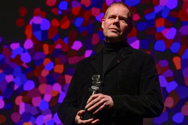 British composer Max Richter poses with the Berlinale Camera award at the 76th Berlinale, Europe's first major film festival of the year, in Berlin on February 18, 2026. (Photo by John MACDOUGALL / AFP)