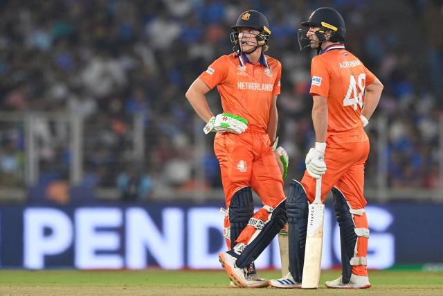 Netherlands' Bas de Leede and Colin Ackermann look on during the 2026 ICC Men's T20 Cricket World Cup group stage match between India and Netherlands at the Narendra Modi Stadium in Ahmedabad on February 18, 2026. (Photo by Shammi MEHRA / AFP)