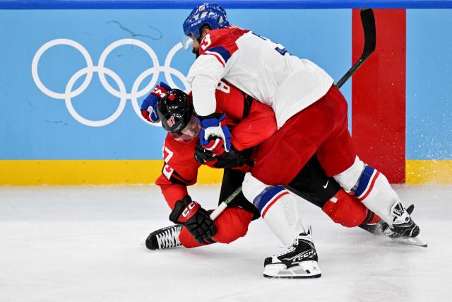 Czech Republic's #03 Radko Gudas (R) tackles Canada's #87 Sidney Crosby during the men's play-off quarter-final ice hockey match between Canada and Czech Republic at the Milano Santagiulia Ice Hockey Arena during the Milano Cortina 2026 Winter Olympic Games in Milan, on February 18, 2026. (Photo by Alexander NEMENOV / AFP)