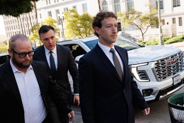 Meta CEO and Chairman Mark Zuckerberg (R) arrives at Los Angeles Superior Court ahead of the social media trial tasked to determine whether social media giants deliberately designed their platforms to be addictive to children, in Los Angeles, on February 18, 2026. Zuckerberg is scheduled to testify Wednesday. (Photo by Patrick T. Fallon / AFP)