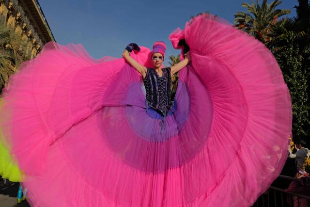An artist performs during the Flower parade, as part the 141st edition of the Nice Carnival in the French Riviera City of Nice on February 18, 2026. The edition 2026 of the Carnival called "Long live the Queen! will take place until March 1, 2026. (Photo by Valery HACHE / AFP)