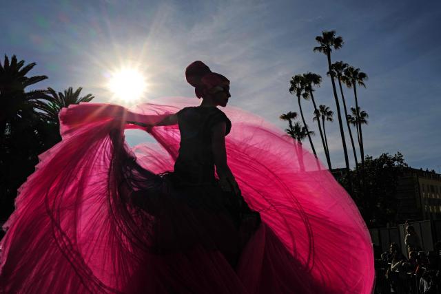 An artist performs during the Flower parade, as part the 141st edition of the Nice Carnival in the French Riviera City of Nice on February 18, 2026. The edition 2026 of the Carnival called "Long live the Queen! will take place until March 1, 2026. (Photo by Valery HACHE / AFP)