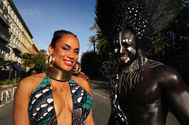Artists pose during the Flower parade, as part the 141st edition of the Nice Carnival in the French Riviera City of Nice on February 18, 2026. The edition 2026 of the Carnival called "Long live the Queen! will take place until March 1, 2026. (Photo by Valery HACHE / AFP)