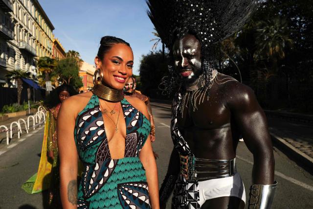 Artists pose during the Flower parade, as part the 141st edition of the Nice Carnival in the French Riviera City of Nice on February 18, 2026. The edition 2026 of the Carnival called "Long live the Queen! will take place until March 1, 2026. (Photo by Valery HACHE / AFP)