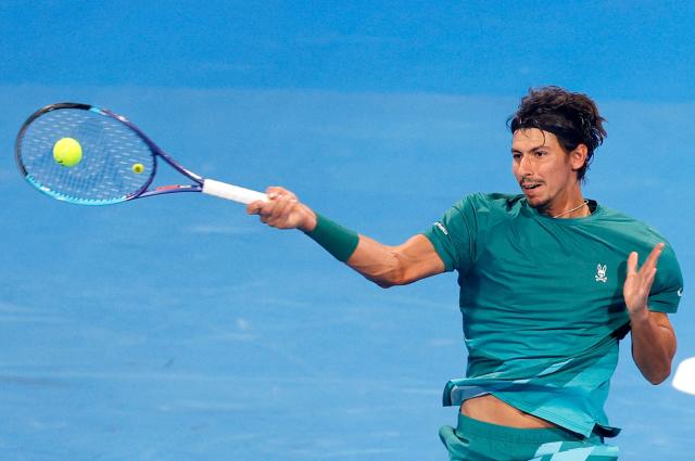 Australia's Alexei Popyrin hits a return against Italy's Jannik Sinner during their men’s singles match at the Qatar Open tennis tournament in Doha on February 18, 2026. (Photo by Karim JAAFAR / AFP)