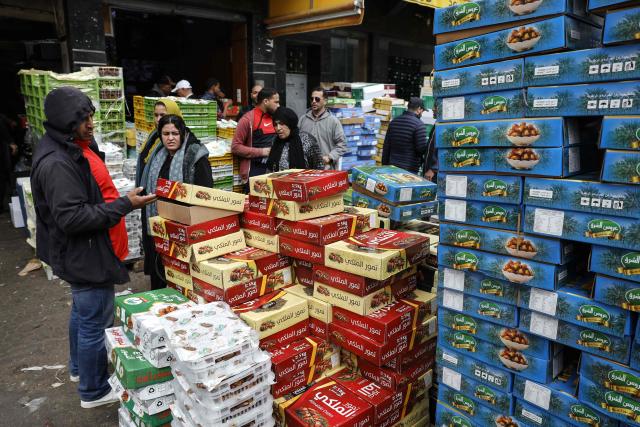 A man looks at boxes of dates at a wholesale market in Casablanca on February 18, 2026, ahead of the start of the holy fasting month of Ramadan. (Photo by Abdel Majid BZIOUAT / AFP)
