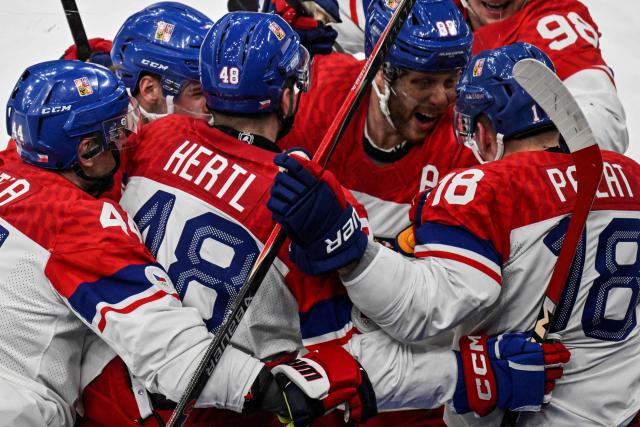Czech Republic's #18 Ondrej Palat celebrates with teammates after scoring his team's third goal during the men's play-off quarter-final ice hockey match between Canada and Czech Republic at the Milano Santagiulia Ice Hockey Arena during the Milano Cortina 2026 Winter Olympic Games in Milan, on February 18, 2026. (Photo by Alexander NEMENOV / AFP)