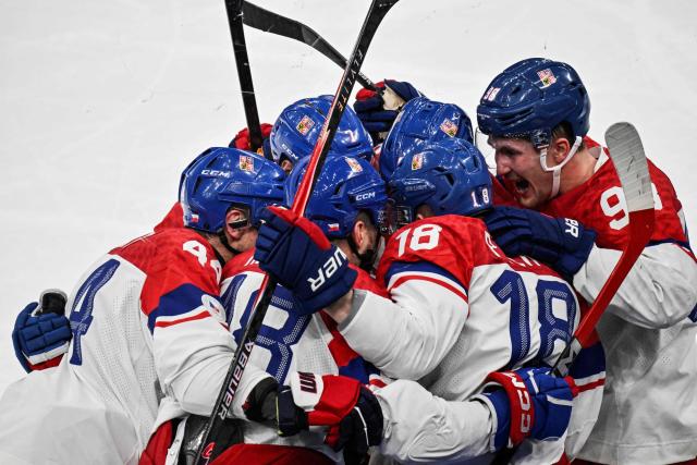 Czech Republic's #18 Ondrej Palat celebrates with teammates after scoring his team's third goal during the men's play-off quarter-final ice hockey match between Canada and Czech Republic at the Milano Santagiulia Ice Hockey Arena during the Milano Cortina 2026 Winter Olympic Games in Milan, on February 18, 2026. (Photo by Alexander NEMENOV / AFP)