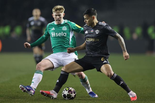Newcastle United's English midfielder #20 Lewis Hall and Qarabag's Brazilian defender #02 Matheus Silva vie for the ball during the UEFA Champions League knockout phase play-off first leg football match between Qarabag and Newcastle at the Tofiq Bahramov Republican Stadium in Baku on February 18, 2026. (Photo by Giorgi ARJEVANIDZE / AFP)