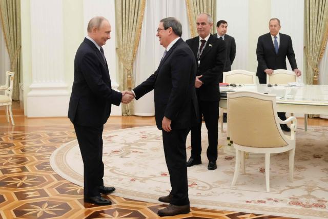 Russian President Vladimir Putin greets Cuban Foreign Minister Bruno Rodriguez Parrilla during their meeting at the Senate Palace of the Kremlin in Moscow on February 18, 2026. (Photo by Pavel Bednyakov / POOL / AFP)