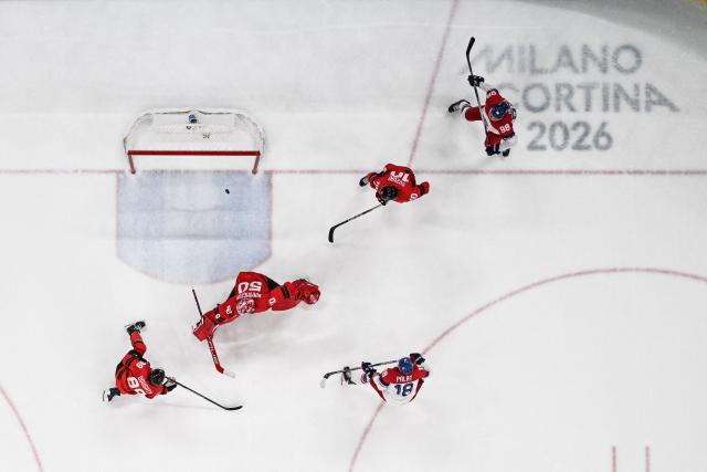 Czech Republic's #18 Ondrej Palat shoots and scores his team third goal during the men's play-off quarter-final ice hockey match between Canada and Czech Republic at the Milano Santagiulia Ice Hockey Arena during the Milano Cortina 2026 Winter Olympic Games in Milan, on February 18, 2026. (Photo by Alexander NEMENOV / AFP)