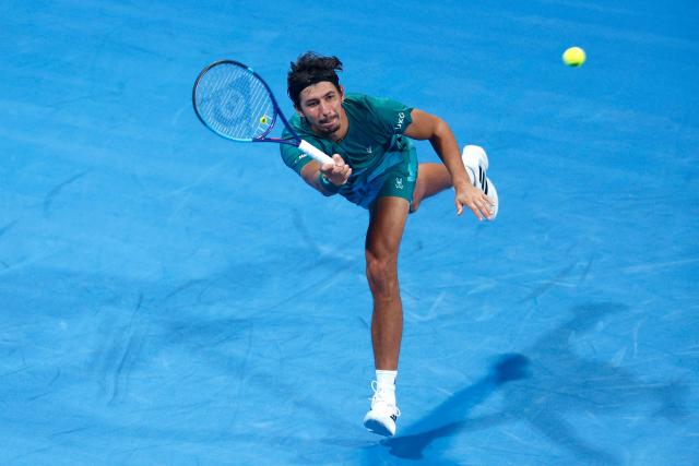 Australia's Alexei Popyrin hits a return against Italy's Jannik Sinner during their men’s singles match at the Qatar Open tennis tournament in Doha on February 18, 2026. (Photo by Karim JAAFAR / AFP)
