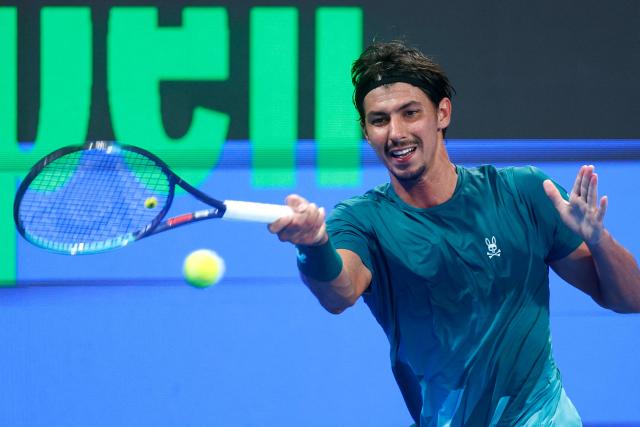 Australia's Alexei Popyrin hits a return against Italy's Jannik Sinner during their men’s singles match at the Qatar Open tennis tournament in Doha on February 18, 2026. (Photo by Karim JAAFAR / AFP)