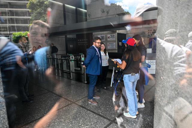 Relatives of political prisoners speak with staffers of the United Nations during a protest outside of the UN headquarters in Caracas, on February 18, 2026. With dark circles under their eyes and feeling weak but angry, about a dozen female relatives of Venezuelan political prisoners staged day five of a hunger strike Wednesday demanding their loved ones' immediate release. (Photo by Juan BARRETO / AFP)