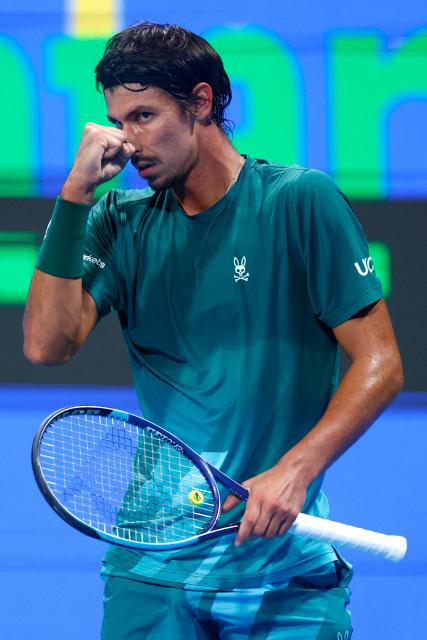 Australia's Alexei Popyrin reacts after a point against Italy's Jannik Sinner during their men’s singles match at the Qatar Open tennis tournament in Doha on February 18, 2026. (Photo by Karim JAAFAR / AFP)