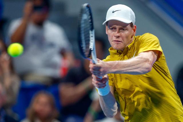 Italy's Jannik Sinner hits a return against Australia's Alexei Popyrin during their men’s singles match at the Qatar Open tennis tournament in Doha on February 18, 2026. (Photo by Karim JAAFAR / AFP)