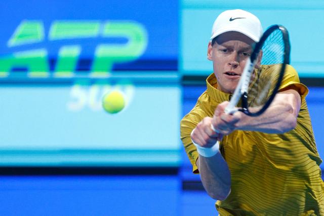 Italy's Jannik Sinner hits a return against Australia's Alexei Popyrin during their men’s singles match at the Qatar Open tennis tournament in Doha on February 18, 2026. (Photo by Karim JAAFAR / AFP)