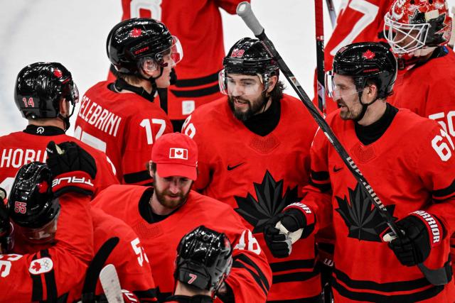 Canada's teammates celebrate after winning the men's play-off quarter-final ice hockey match between Canada and Czech Republic at the Milano Santagiulia Ice Hockey Arena during the Milano Cortina 2026 Winter Olympic Games in Milan, on February 18, 2026. Canada wins 4 - 3 against Czech Republic and is qualified for the semi-finals. (Photo by Alexander NEMENOV / AFP)