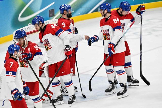 Czech Republic 's teammates react at the end of the men's play-off quarter-final ice hockey match between Canada and Czech Republic at the Milano Santagiulia Ice Hockey Arena during the Milano Cortina 2026 Winter Olympic Games in Milan, on February 18, 2026. Canada wins 4 - 3 against Czech Republic and is qualified for the semi-finals. (Photo by Alexander NEMENOV / AFP)