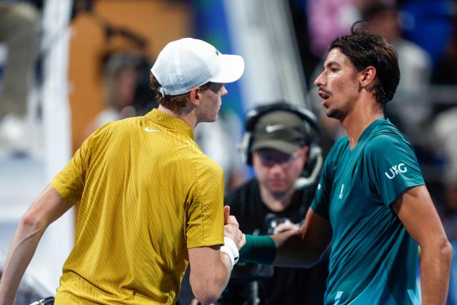 Italy's Jannik Sinner greets Australia's Alexei Popyrin after their men’s singles match at the Qatar Open tennis tournament in Doha on February 18, 2026. (Photo by Karim JAAFAR / AFP)