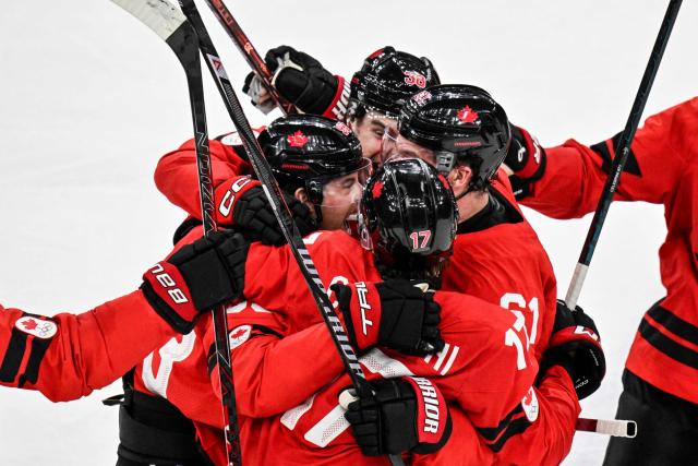 Canada's #93 Mitch Marner celebrates with teammates after scoring his team's fourth goal to win the men's play-off quarter-final ice hockey match between Canada and Czech Republic at the Milano Santagiulia Ice Hockey Arena during the Milano Cortina 2026 Winter Olympic Games in Milan, on February 18, 2026. Canada wins 4 - 3 against Czech Republic and is qualified for the semi-finals. (Photo by Alexander NEMENOV / AFP)