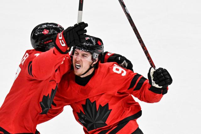 Canada's #93 Mitch Marner celebrates with teammates after scoring his team's fourth goal to win the men's play-off quarter-final ice hockey match between Canada and Czech Republic at the Milano Santagiulia Ice Hockey Arena during the Milano Cortina 2026 Winter Olympic Games in Milan, on February 18, 2026. Canada wins 4 - 3 against Czech Republic and is qualified for the semi-finals. (Photo by Alexander NEMENOV / AFP)