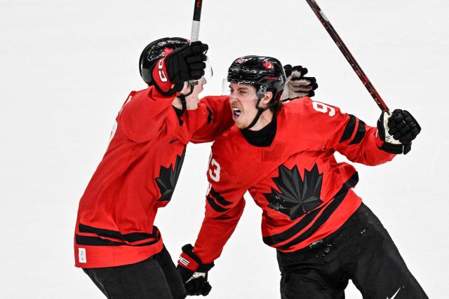 Canada's #93 Mitch Marner celebrates with teammates after scoring his team's fourth goal to win the men's play-off quarter-final ice hockey match between Canada and Czech Republic at the Milano Santagiulia Ice Hockey Arena during the Milano Cortina 2026 Winter Olympic Games in Milan, on February 18, 2026. Canada wins 4 - 3 against Czech Republic and is qualified for the semi-finals. (Photo by Alexander NEMENOV / AFP)
