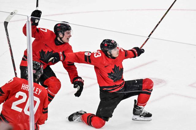 Canada's #93 Mitch Marner celebrates with teammates after scoring his team's fourth goal to win the men's play-off quarter-final ice hockey match between Canada and Czech Republic at the Milano Santagiulia Ice Hockey Arena during the Milano Cortina 2026 Winter Olympic Games in Milan, on February 18, 2026. Canada wins 4 - 3 against Czech Republic and is qualified for the semi-finals. (Photo by Alexander NEMENOV / AFP)