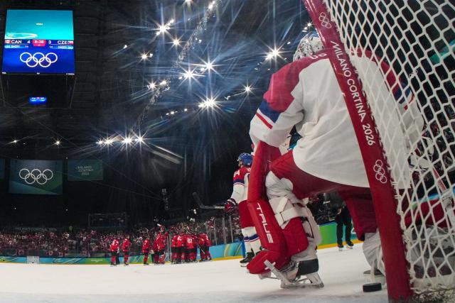 Canada's teammates celebrate after winning the men's play-off quarter-final ice hockey match between Canada and Czech Republic at the Milano Santagiulia Ice Hockey Arena during the Milano Cortina 2026 Winter Olympic Games in Milan, on February 18, 2026. Canada wins 4 - 3 against Czech Republic and is qualified for the semi-finals. (Photo by POOL / AFP)