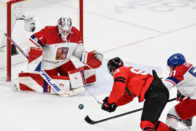 Canada's #93 Mitch Marner (C) shoots and scores his team fourth goal during the men's play-off quarter-final ice hockey match between Canada and Czech Republic at the Milano Santagiulia Ice Hockey Arena during the Milano Cortina 2026 Winter Olympic Games in Milan, on February 18, 2026. (Photo by Alexander NEMENOV / AFP)