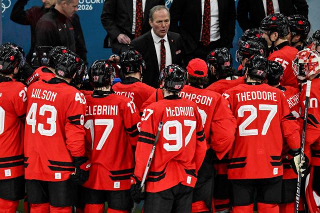 Canada's team players celebrate with their coach Canada's head coach Jon Cooper (rear C) after winning the men's play-off quarter-final ice hockey match between Canada and Czech Republic at the Milano Santagiulia Ice Hockey Arena during the Milano Cortina 2026 Winter Olympic Games in Milan, on February 18, 2026. Canada wins 4 - 3 against Czech Republic and is qualified for the semi-finals. (Photo by Alexander NEMENOV / AFP)