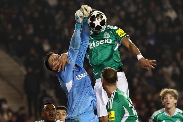 Qarabag's Polish goalkeeper #99 Mateusz Kochalski and Newcastle United's German defender #12 Malick Thiaw vie for the ball during the UEFA Champions League knockout phase play-off first leg football match between Qarabag and Newcastle at the Tofiq Bahramov Republican Stadium in Baku on February 18, 2026. (Photo by Giorgi ARJEVANIDZE / AFP)