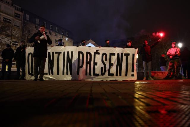 Demonstrators stand behind a banner during a rally in tribute of Quentin Deranque in Lille, northern France, on February 18, 2026, following his death on the sidelines of a far-right protest against a left-wing politician speaking at a university in the southeastern city of Lyon. (Photo by Sameer AL-DOUMY / AFP)
