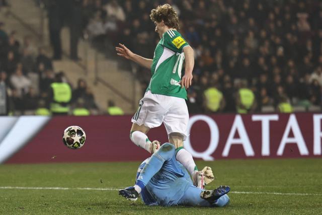 Qarabag's Polish goalkeeper #99 Mateusz Kochalski fouls Newcastle United's English midfielder #10 Anthony Gordon during the UEFA Champions League knockout phase play-off first leg football match between Qarabag and Newcastle at the Tofiq Bahramov Republican Stadium in Baku on February 18, 2026. (Photo by Giorgi ARJEVANIDZE / AFP)