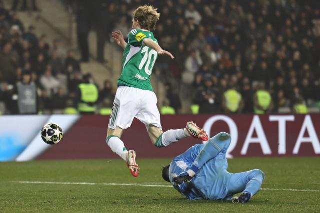 Qarabag's Polish goalkeeper #99 Mateusz Kochalski fouls Newcastle United's English midfielder #10 Anthony Gordon during the UEFA Champions League knockout phase play-off first leg football match between Qarabag and Newcastle at the Tofiq Bahramov Republican Stadium in Baku on February 18, 2026. (Photo by Giorgi ARJEVANIDZE / AFP)