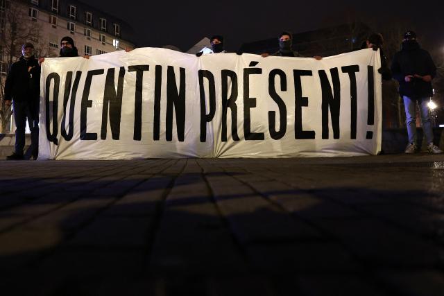 Demonstrators stand behind a banner during a rally in tribute of Quentin Deranque in Lille, northern France, on February 18, 2026, following his death on the sidelines of a far-right protest against a left-wing politician speaking at a university in the southeastern city of Lyon. (Photo by Sameer AL-DOUMY / AFP)