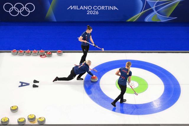 Britain's Sophie Jackson and Britain's Sophie Sinclair compete in the curling women's round robin between Britain and Japan during the Milano Cortina 2026 Winter Olympic Games at the Cortina Curling Olympic Stadium in Cortina d’Ampezzo on February 18, 2026. (Photo by Wikus de WET / AFP)