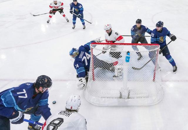 Finland's #74 Juuse Saros (C) makes a save during the men's play-off quarter-final ice hockey match between Finland and Switzerland at the Milano Rho Ice Hockey Arena during the Milano Cortina 2026 Winter Olympic Games in Milan, on February 18, 2026. (Photo by Sun Fei / POOL / AFP)
