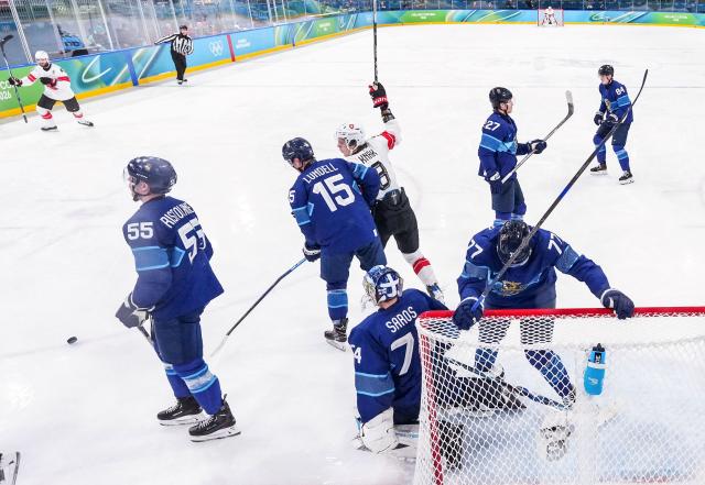 Switzerland's players celebrate after scoring a goal during the men's play-off quarter-final ice hockey match between Finland and Switzerland at the Milano Rho Ice Hockey Arena during the Milano Cortina 2026 Winter Olympic Games in Milan, on February 18, 2026. (Photo by Sun Fei / POOL / AFP)