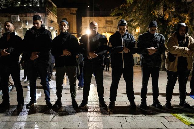 Palestinian Muslim worshippers banned from entering the Al-Aqsa Mosque compound pray outside at the end of the first day of Ramadan in Jerusalem's Old City on February 18, 2026. (Photo by JOHN WESSELS / AFP)