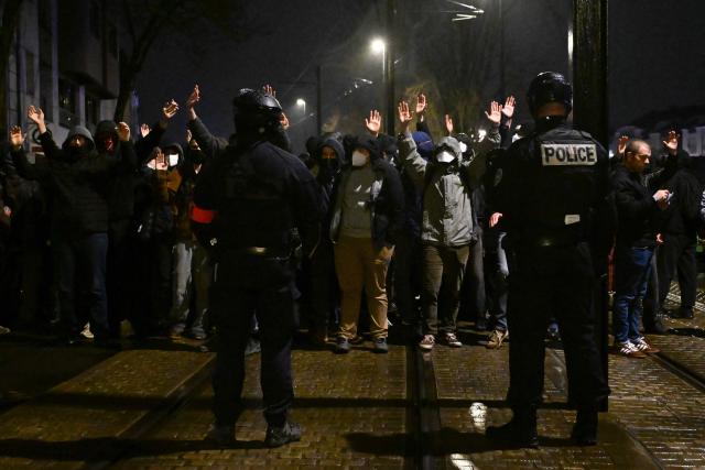 Police Officers face demonstrators during a rally organized by the Nantes Anti-Fascist Assembly in Nantes, western France on February 18, 2026, following the death of far-right sympathiser Quentin Debranque in Lyon. Quentin Deranque, 23, died after sustaining a severe brain injury when he was attacked by at least six people last week on the sidelines of a far-right protest against a left-wing politician speaking at a university in the southeastern city of Lyon. (Photo by Sebastien Salom-Gomis / AFP)
