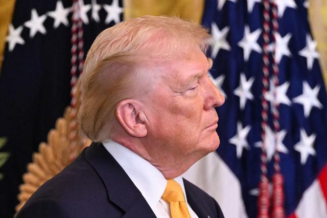 US President Donald Trump looks on as he hosts a Black History Month event in the East Room of the White House in Washington, DC, on February 18, 2026. (Photo by SAUL LOEB / AFP)