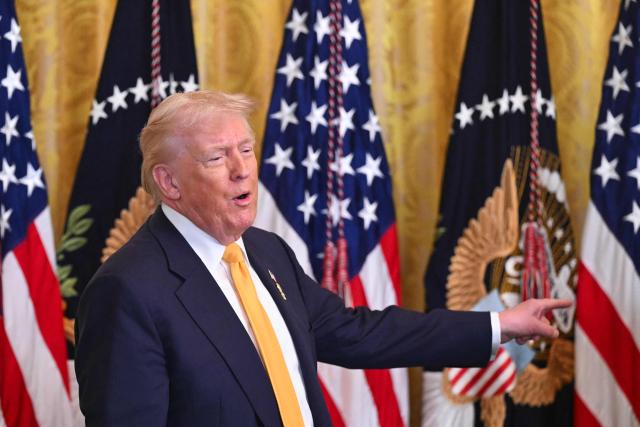 US President Donald Trump gestures as he speaks during a Black History Month event in the East Room of the White House in Washington, DC, on February 18, 2026. (Photo by SAUL LOEB / AFP)