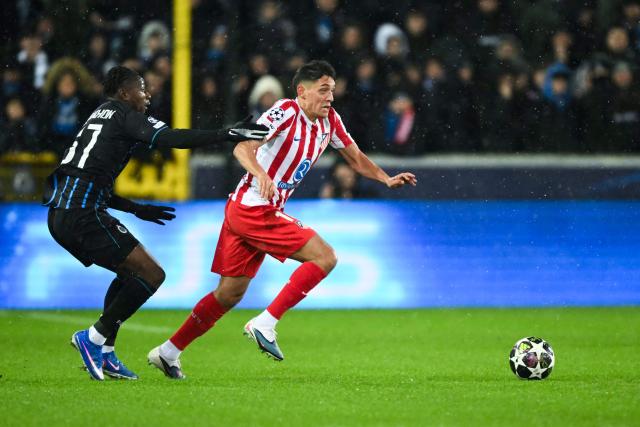Club Brugge's French forward #67 Mamadou Diakhon and Atletico Madrid's Argentine defender #16 Nahuel Molina fight for the ball during the UEFA Champions League knockout round play-off first leg football match between Club Brugge and Atletico Madrid at the Jan Breydel Stadium in Brugge on February 18, 2026. (Photo by NICOLAS TUCAT / AFP)