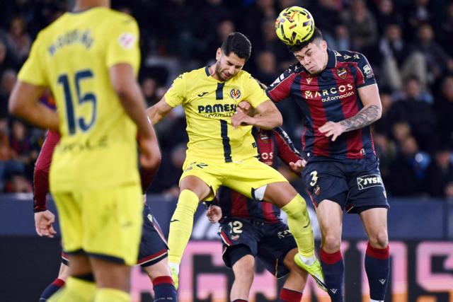 Levante's Uruguayan defender #03 Alan Matturro (R) and Villarreal's Spanish forward #22 Ayoze Perez Gutierrez vie for a header during the Spanish league football match between Levante UD and Villarreal CF at Ciutat de Valencia Stadium in Valencia on February 18, 2026. (Photo by JOSE JORDAN / AFP)