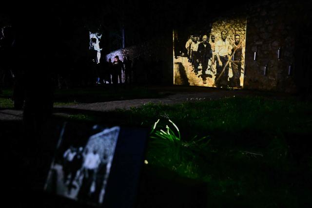 A recently released photograph of Greek Communist political prisoners before their execution is projected onto a wall of the memorial site at the Kaisariani Shooting Range where 200 Greek Communist political prisoners were executed by Nazi as part of a demonstration called by the Greek Communist Party (KKE) in the neighbourhood of Kaisariani in Athens on February 18, 2026. The Greek Communist Party is fighting to ensure that the recently released photographs of the execution of 200 Greek Communist political prisoners by the Nazi occupation forces at the Kaisariani Shooting Range in Athens on May 1, 1944, are not owned as part of a private collection but are instead donated to the EAM Museum of National Resistance. (Photo by Aggelos NAKKAS / AFP)